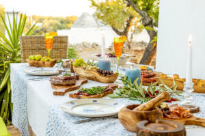 Olive wood products on dinner table in the garden