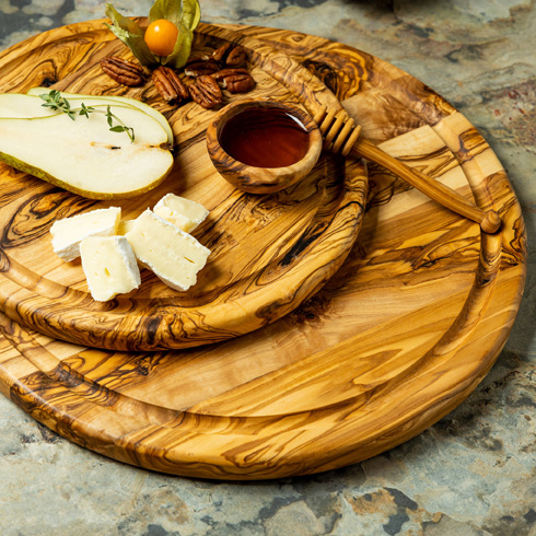 Tunisian Olive wood round cutting boards with pears, cheese, and honey on top