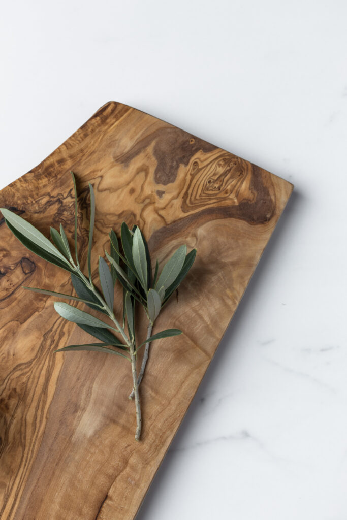Tunisian olive wood board with olive branch on top