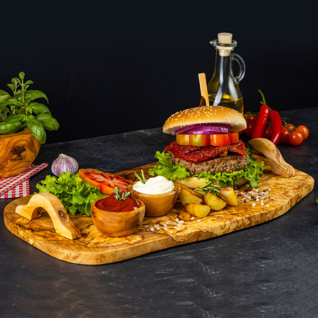 Olive wood serving board with burger on top
