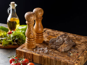 Olive wood salt and pepper mills on olive wood chopping block