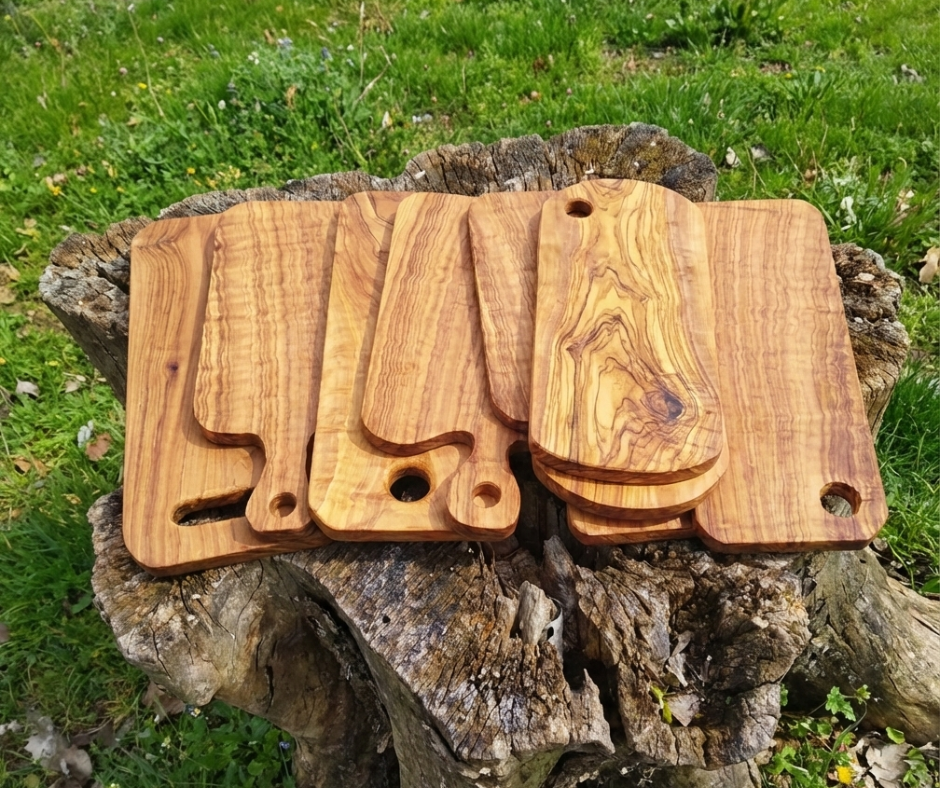 olive wood products boards on a tree trunk