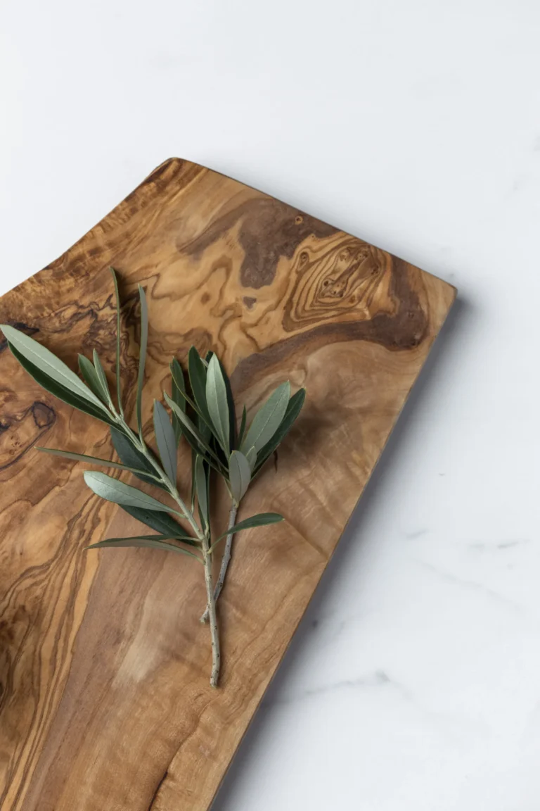 olive wood board with olive wood branch on top